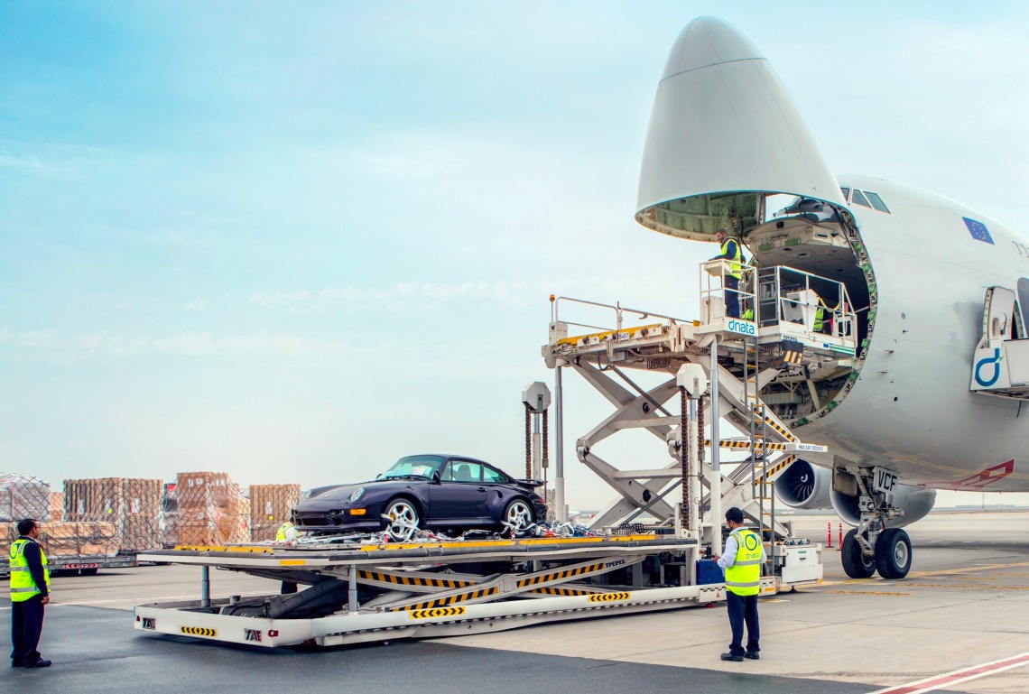 Luxury car being transported by a plane